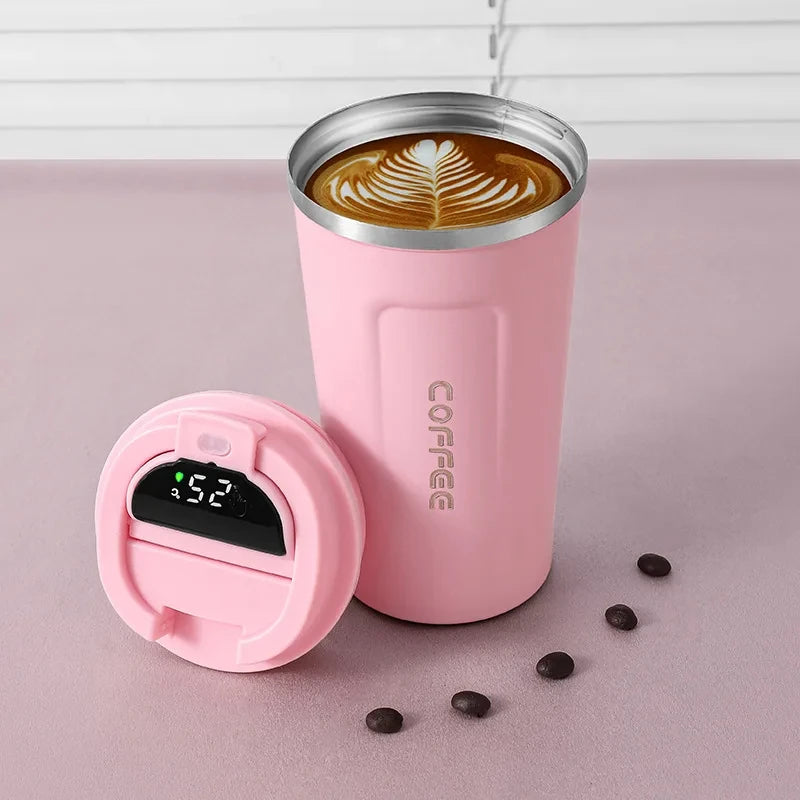 Pink coffee tumbler with digital temperature display on a pink background