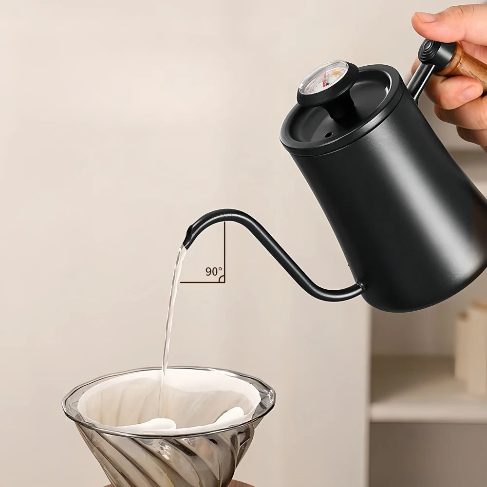 Black pour-over coffee maker being used to pour water into a glass filter.