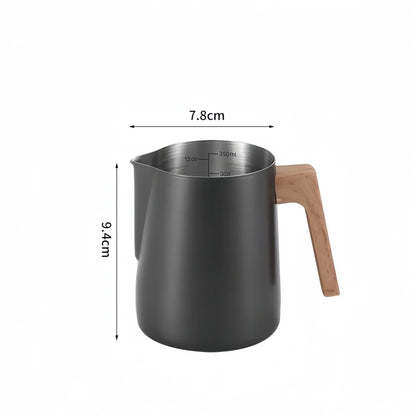 Black milk pitcher with wooden handle and measurements on a white background