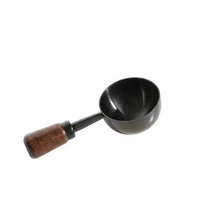 A small black metal scoop or ladle with a brown wooden handle, shown on a plain white background.