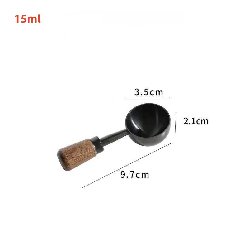 A small black metal scoop or ladle with a brown wooden handle, shown on a plain white background.