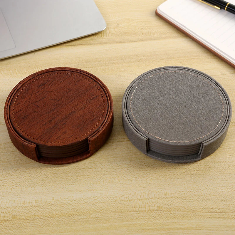 Two round wooden coasters, one brown and one gray, on a light wood surface.