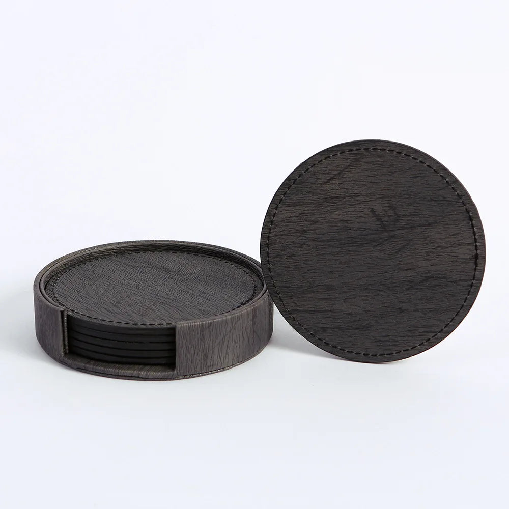 Set of black coasters with a holder on a white background