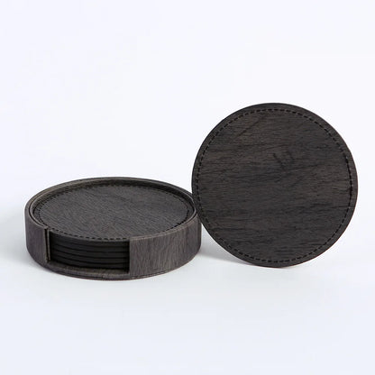 Set of black coasters with a holder on a white background