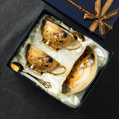 Decorative gold coffee set with a spoon in a gift box on a dark background