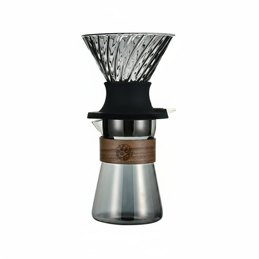 Glass coffee dripper with wooden collar and black silicone sleeve.