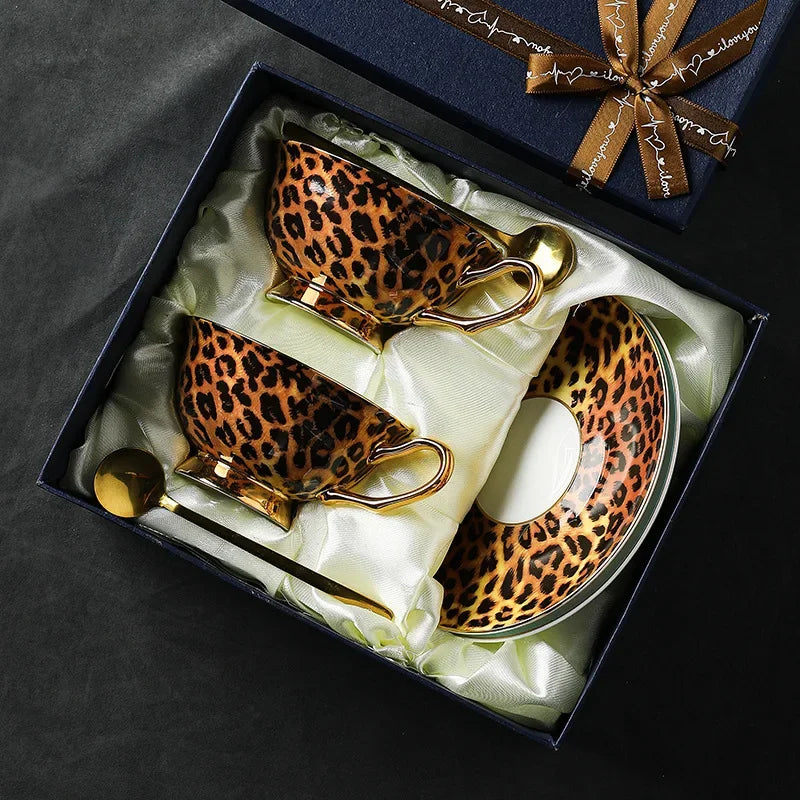 Leopard print teacup set with gold accents in a decorative box.