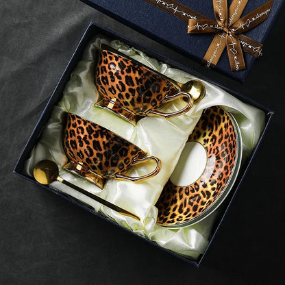 Leopard print teacup set with gold accents in a decorative box.