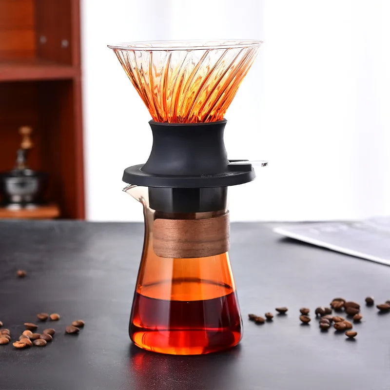 Coffee brewing device with orange filter on a dark surface with coffee beans.