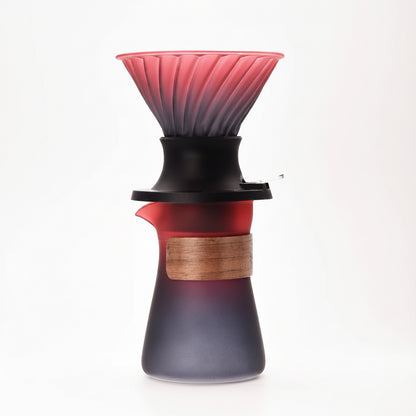 Glass coffee dripper with wooden collar on a white background