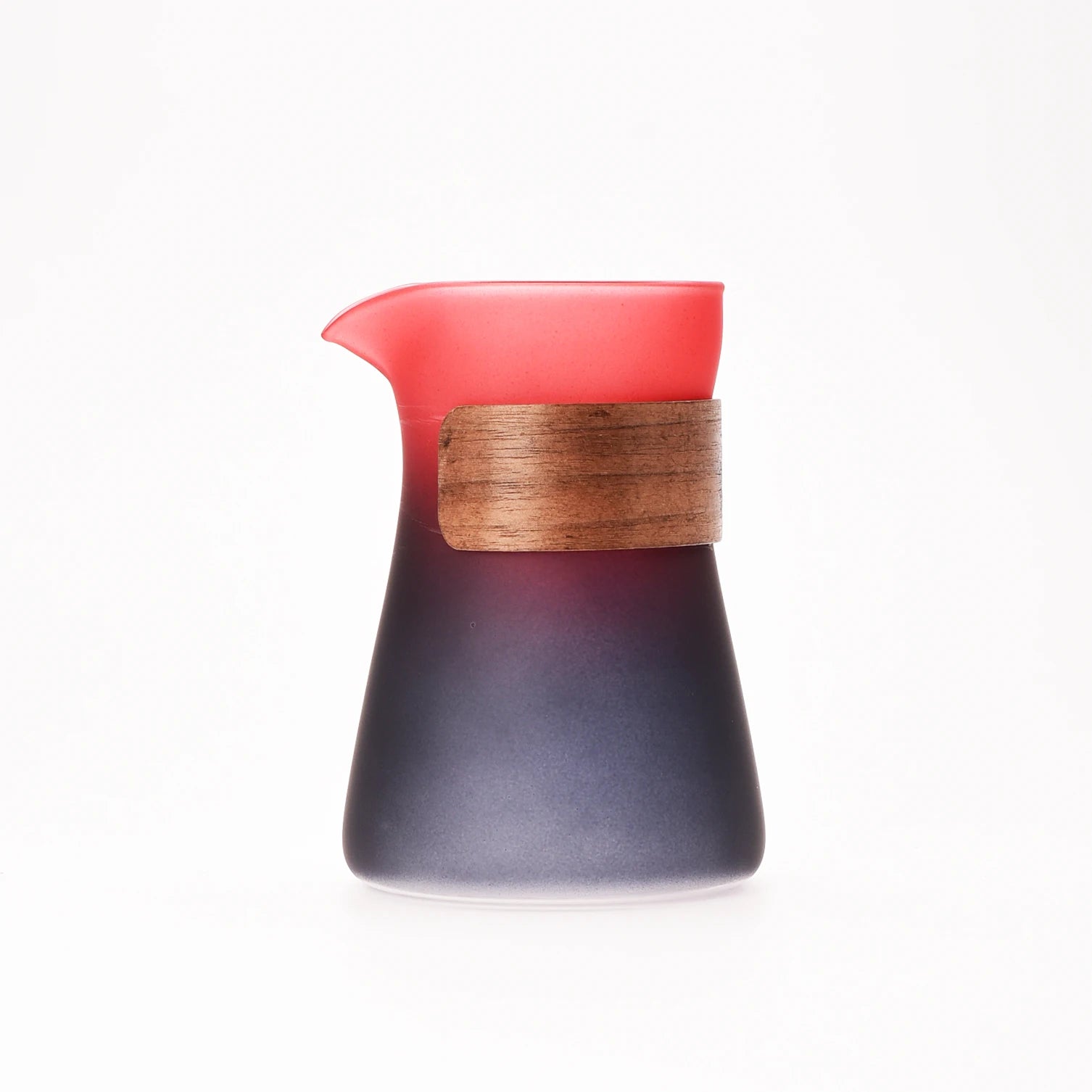 Glass pitcher with wooden handle on a white background