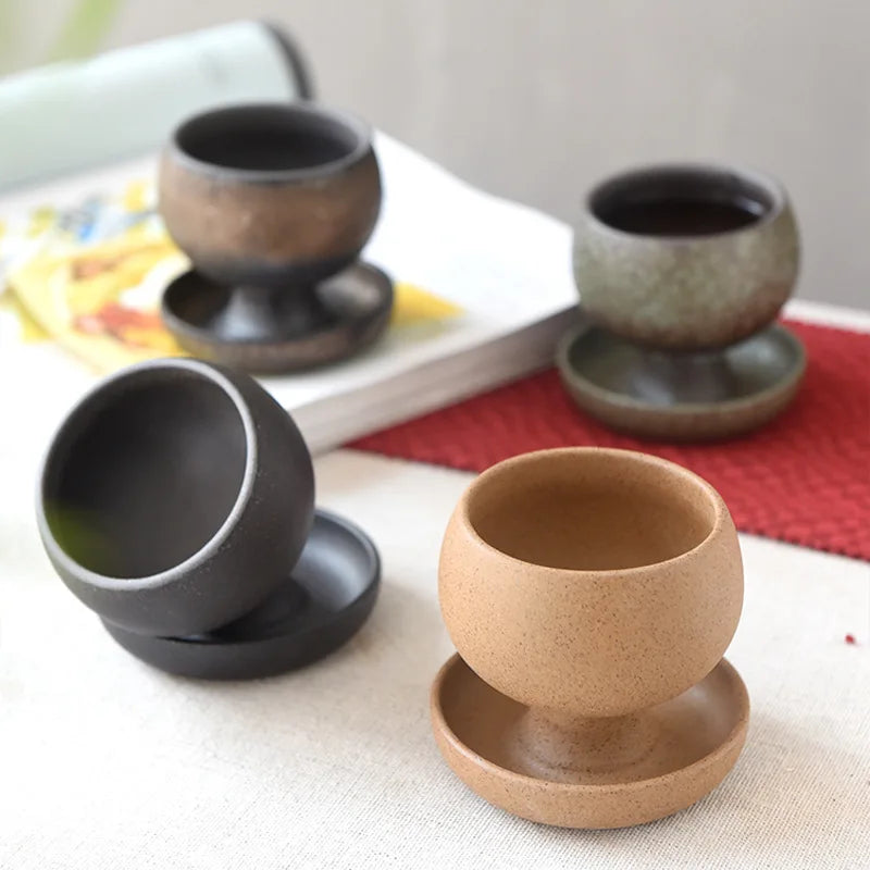 Set of ceramic egg cups in different colors on a table.