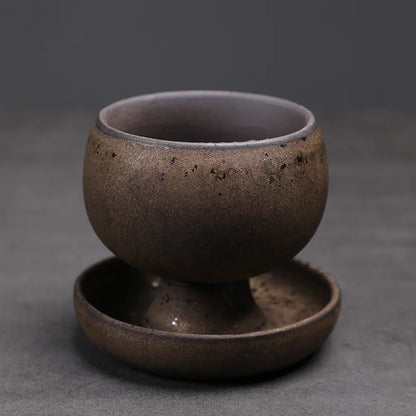 Brown ceramic cup and saucer on a dark gray background