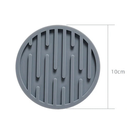 Gray silicone mat with textured design and measurement label on a white background