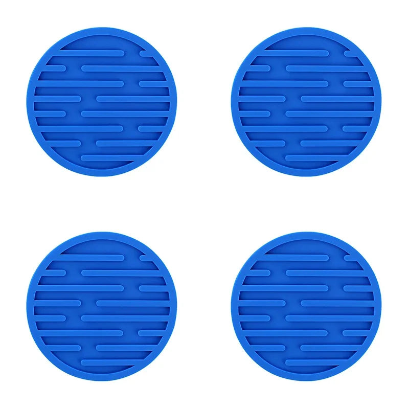 Four blue silicone trivets with textured surface on a white background