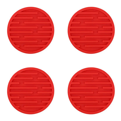 Four red silicone coasters on a white background