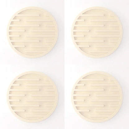 Four round beige coasters with a textured surface on a white background