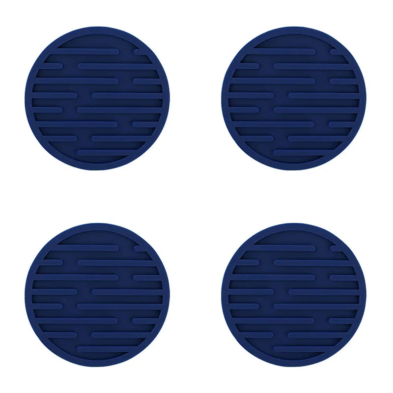 Four blue silicone coasters with a textured surface on a white background