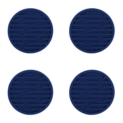 Four blue silicone coasters with a textured surface on a white background