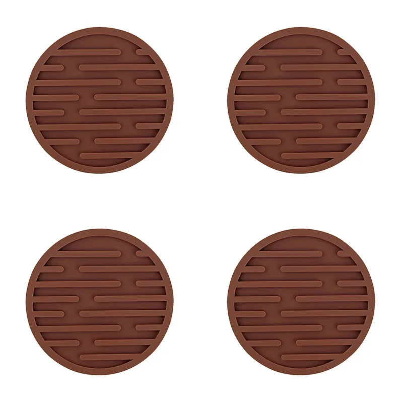 Four brown round trivets with textured surface on a white background