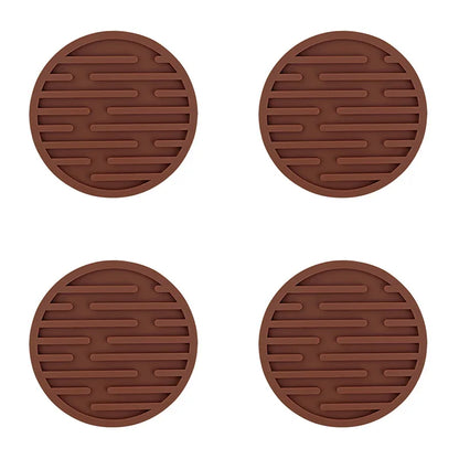 Four brown round trivets with textured surface on a white background