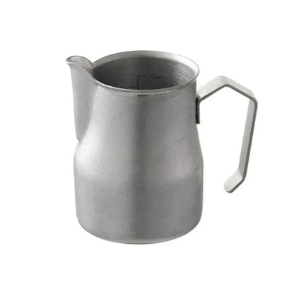 A stainless steel milk pitcher on a white background.
