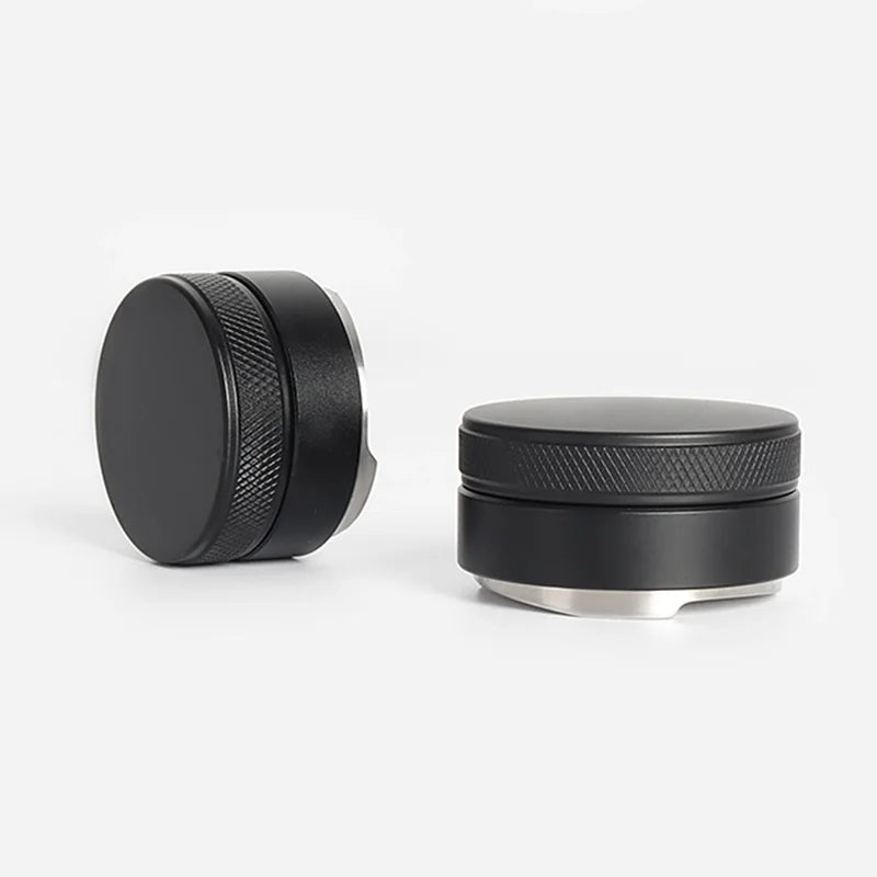 Two black metal grinder components on a white background