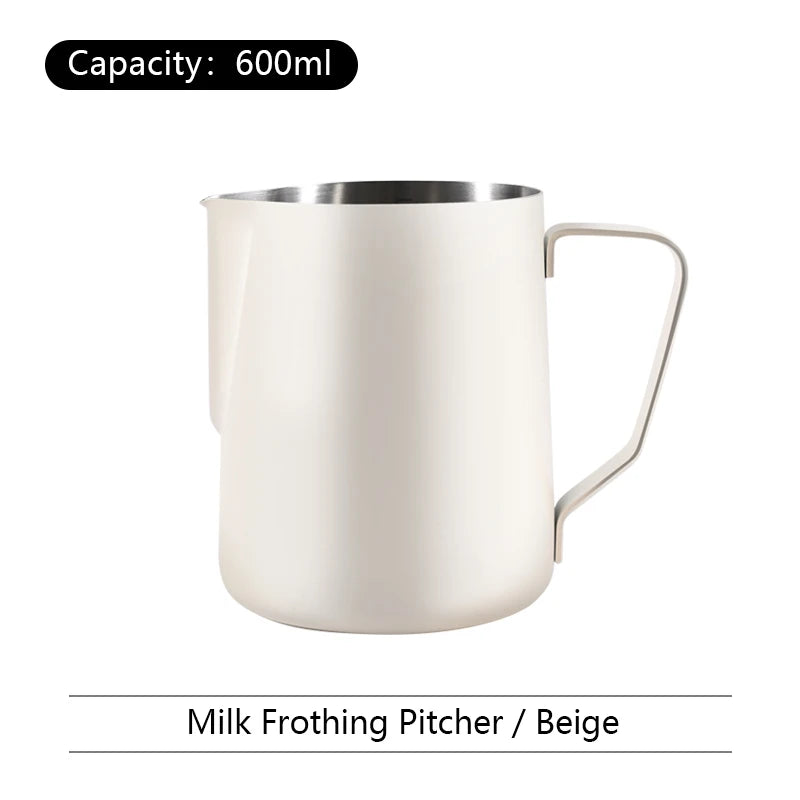Beige milk frothing pitcher with capacity label on a white background