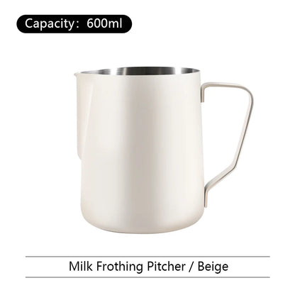 Beige milk frothing pitcher with capacity label on a white background