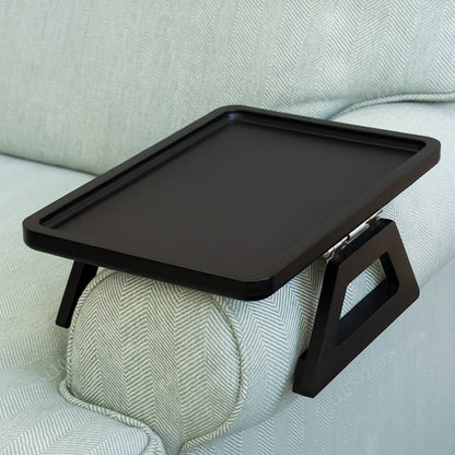 Black adjustable tray on a light gray sofa