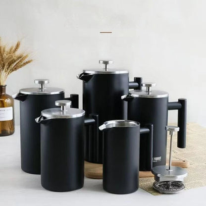 Set of black French press coffee makers on a light surface with a neutral background