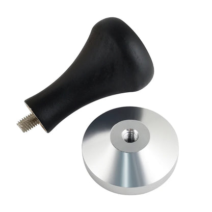 Black coffee tamper handle with metal disc on a white background