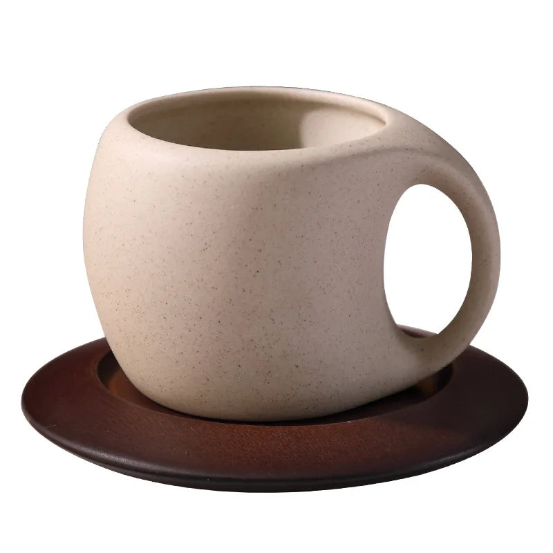 Beige ceramic mug with brown base on a white background