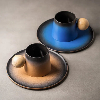 Two ceramic cups with saucers on a gray surface