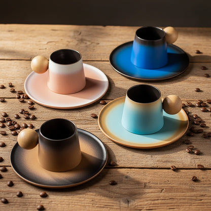 Set of four ceramic cups with gradient colors on a gray surface