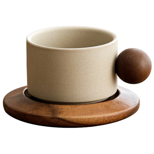 Beige ceramic cup with wooden base and handle on a white background