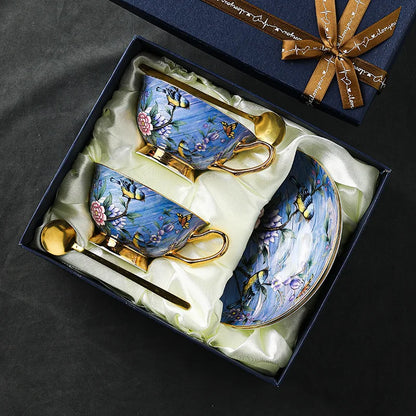 Decorative tea set with floral designs in a gift box on a dark background