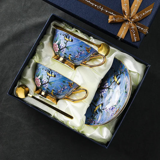 Decorative tea set with floral designs in a gift box on a dark background