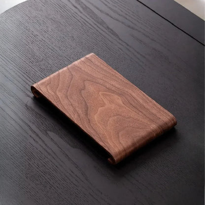 Wooden wallet on a dark wooden surface