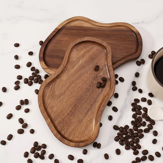 Two wooden trays on a marble surface with coffee beans