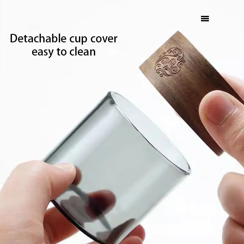 Silver cup with wooden cover held by a hand, text 'Detachable cup cover easy to clean' on a white background.