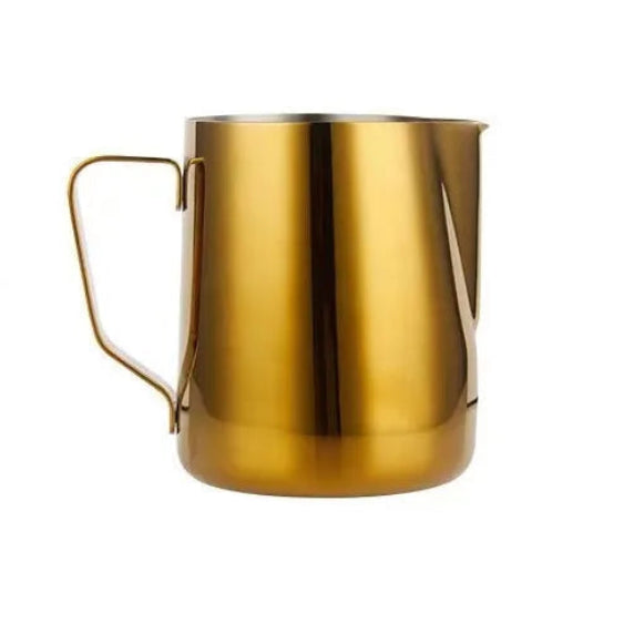 Gold-colored milk frothing pitcher on a white background