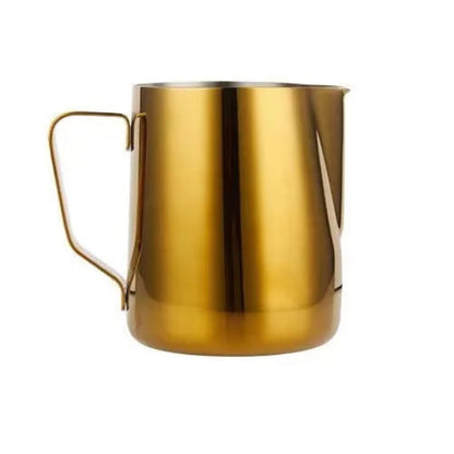 Gold-colored milk frothing pitcher on a white background