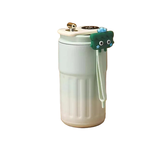 White travel mug with a green cat-shaped handle on a white background