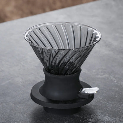 Black and silver coffee dripper on a gray surface