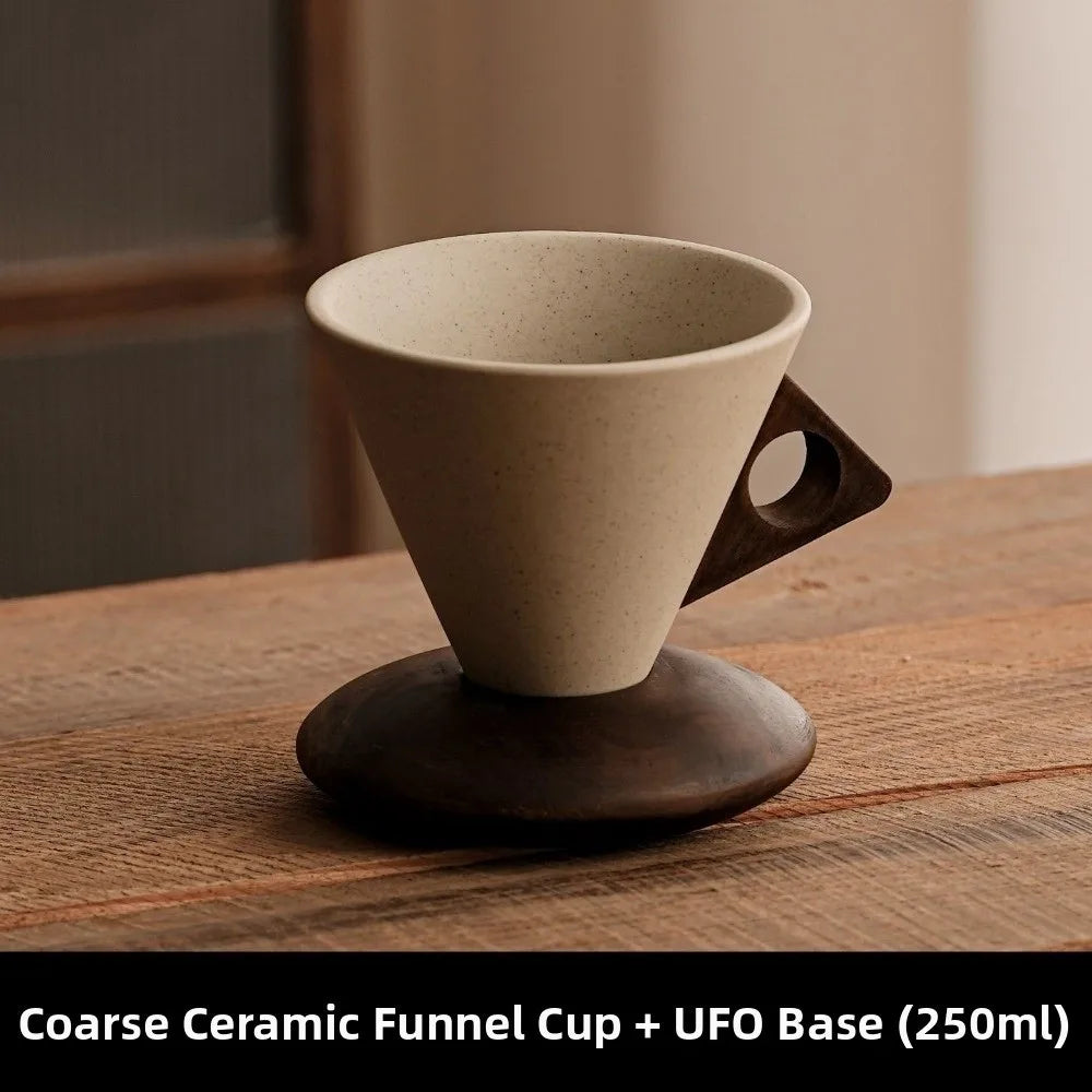 Coarse ceramic funnel cup with UFO base on a wooden surface