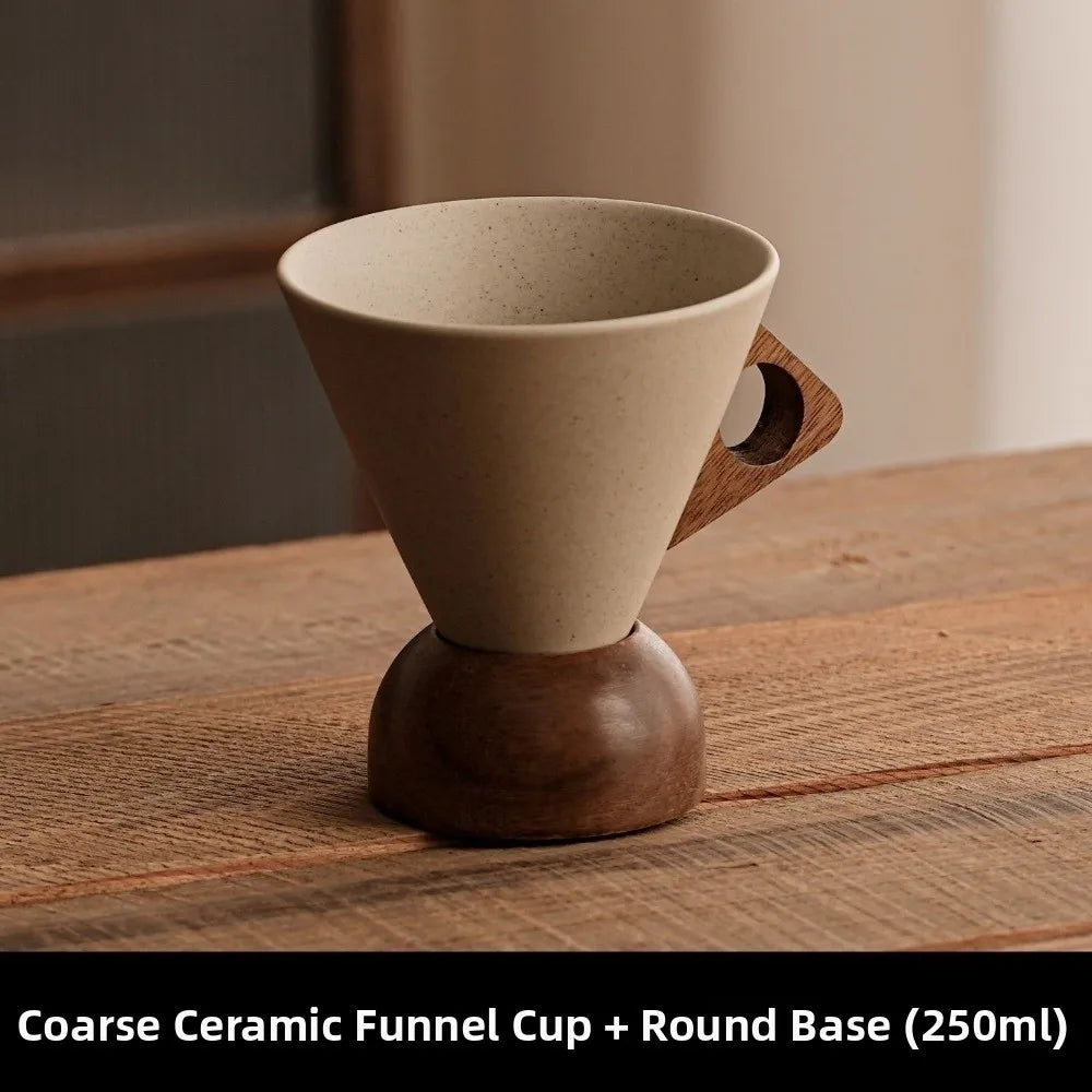 Coarse ceramic funnel cup with wooden handle and base on a wooden surface