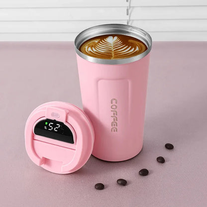 Pink coffee tumbler with digital temperature display on a pink background