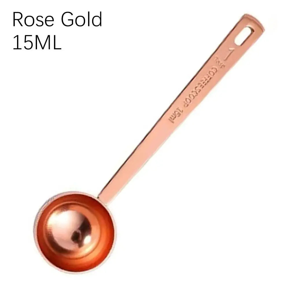 Rose gold measuring spoon with '15ML' text on a white background
