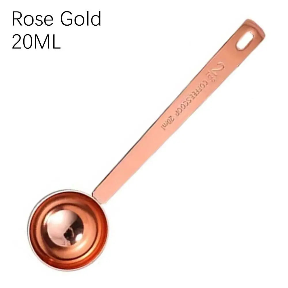 Rose gold measuring spoon with '20ML' text on a white background